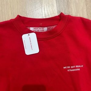 Cozy red crew neck from we’re not really strangers based on the game